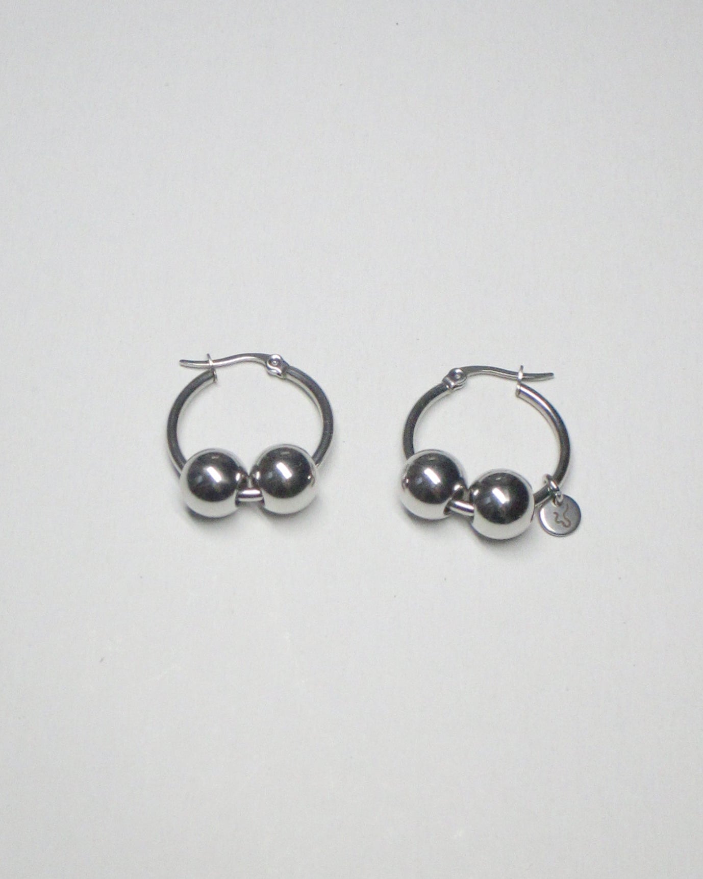 Gemini boulles steel earrings still portrait