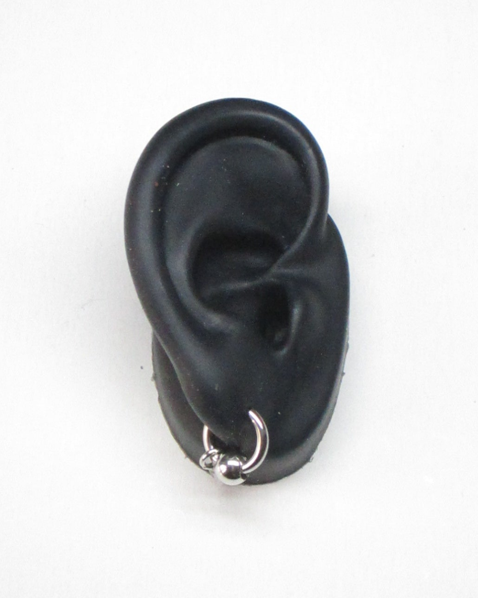 Micro captive piercing style steel single earring portrait on ear model