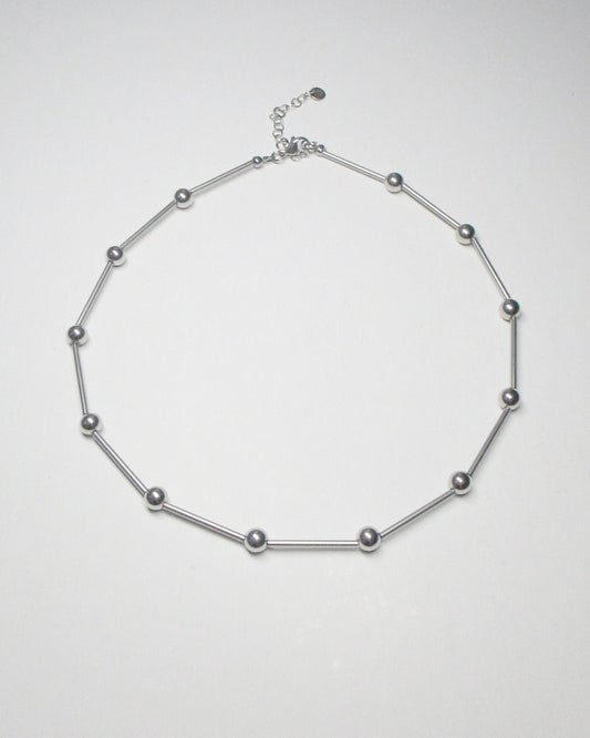 Mille barbells steel necklace still portrait