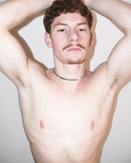 Model frontal portrait wearing snake chain with pearl pendant