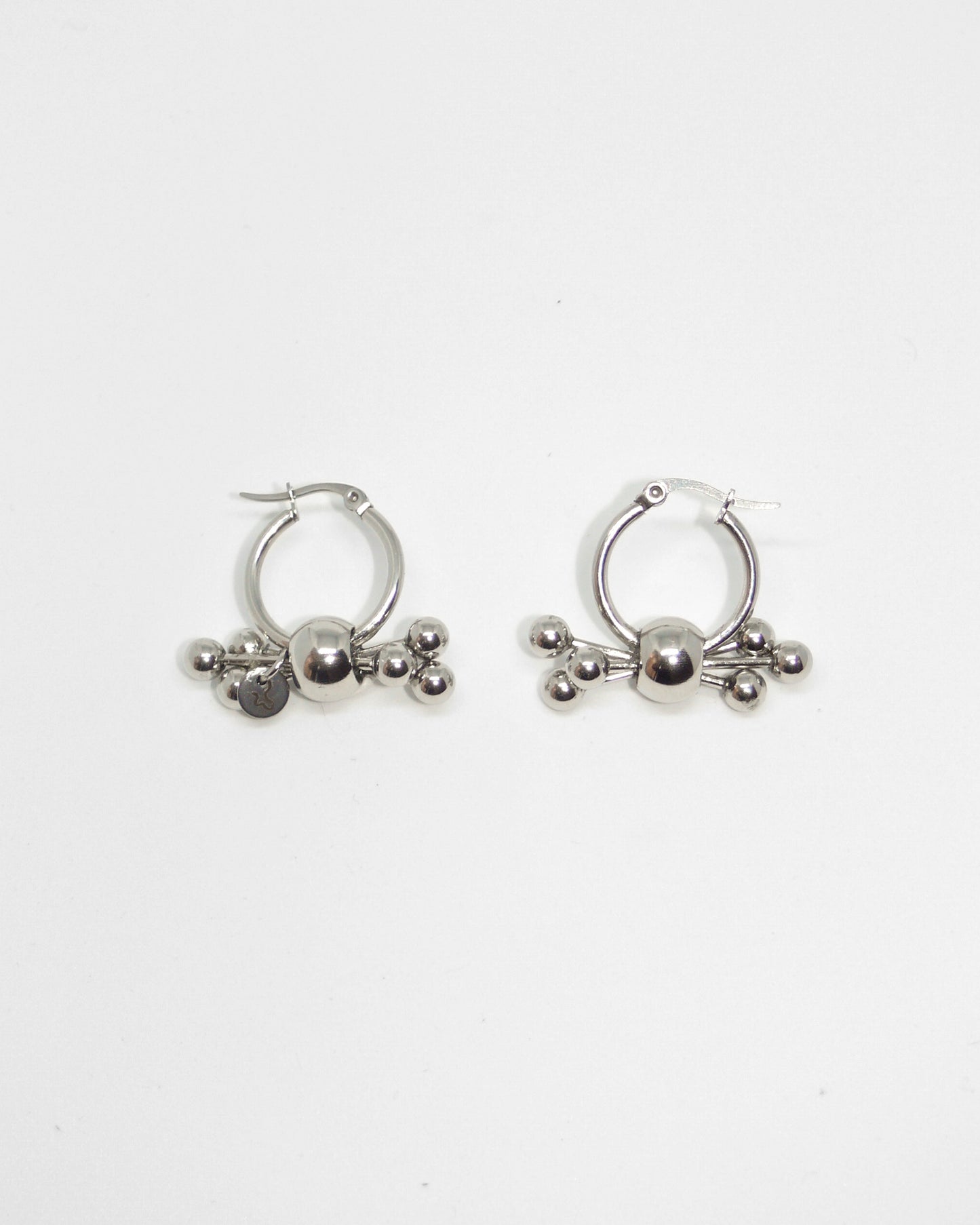 Multiple steel barbells decoration hoop earrings still portrait