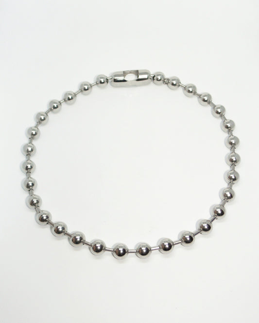 Silver beaded necklace on a white background