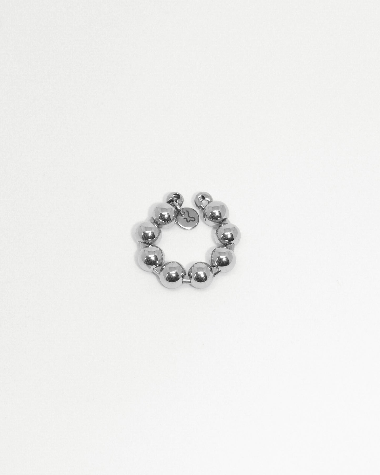 Silver beaded ring on a light gray background