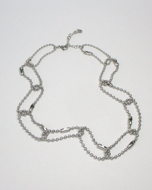Steel ball chain multiple rings necklace fluid still portrait