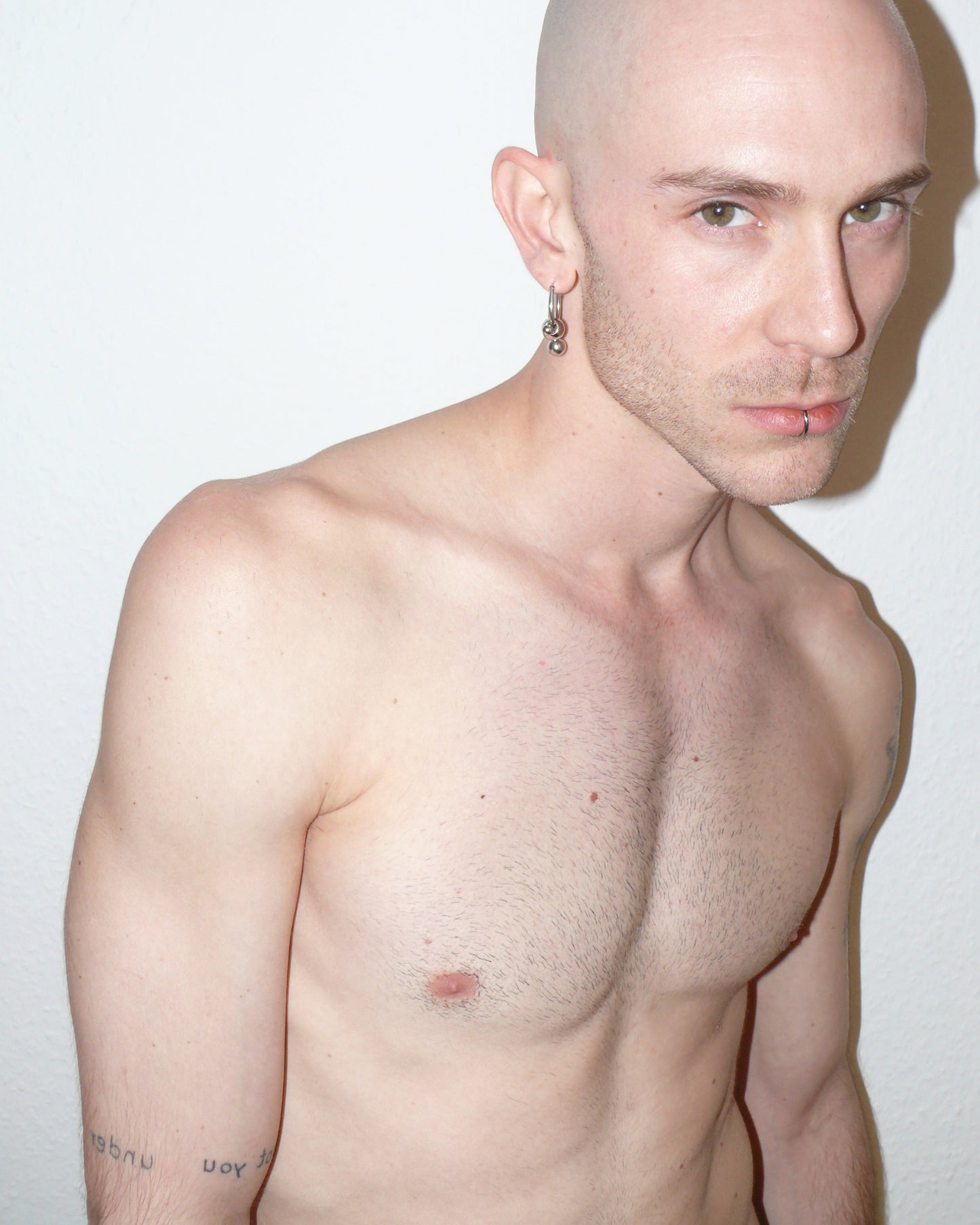 Steel hoops earrings with banana piercings decoration side frontal portrait on model