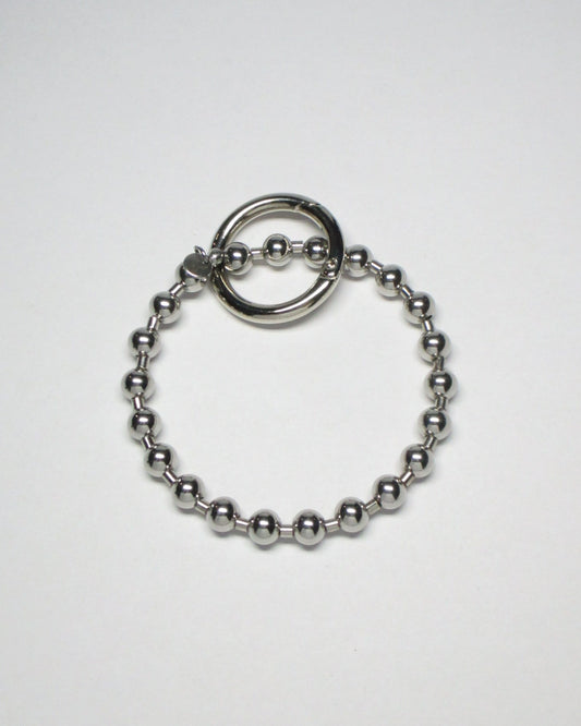 Stell ball chain key and cock ring still portrait