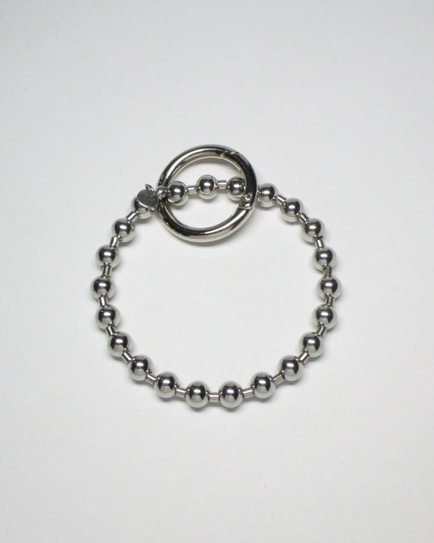 Stell ball chain key and cock ring still portrait