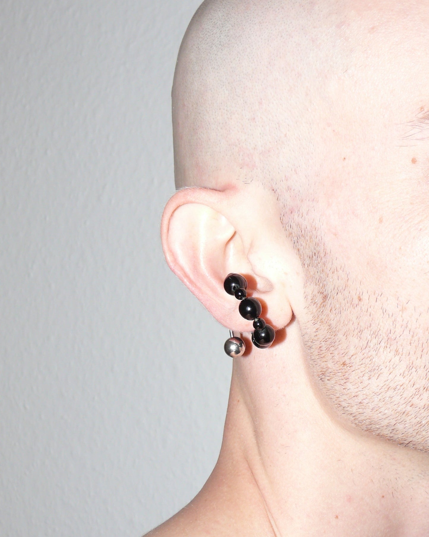 Black agate beads cuff with piercing decoration close-up on model