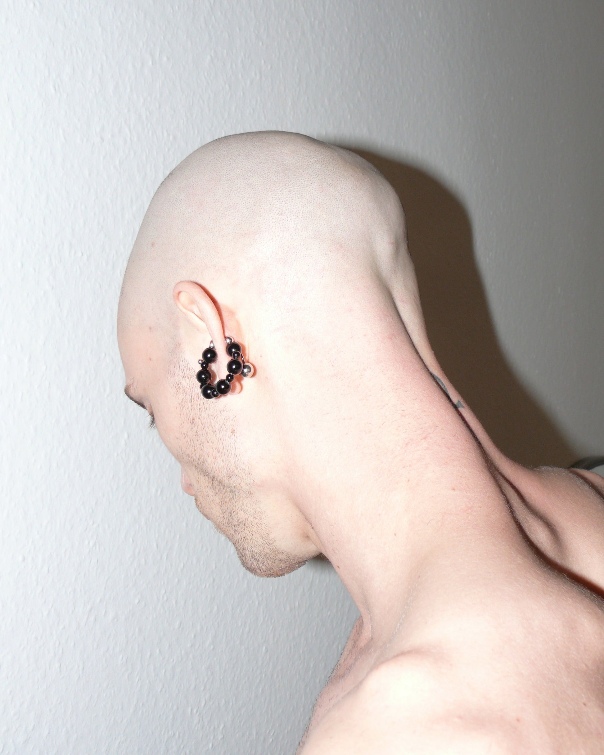 Black agate beads cuff with piercing decoration side portrait on model back