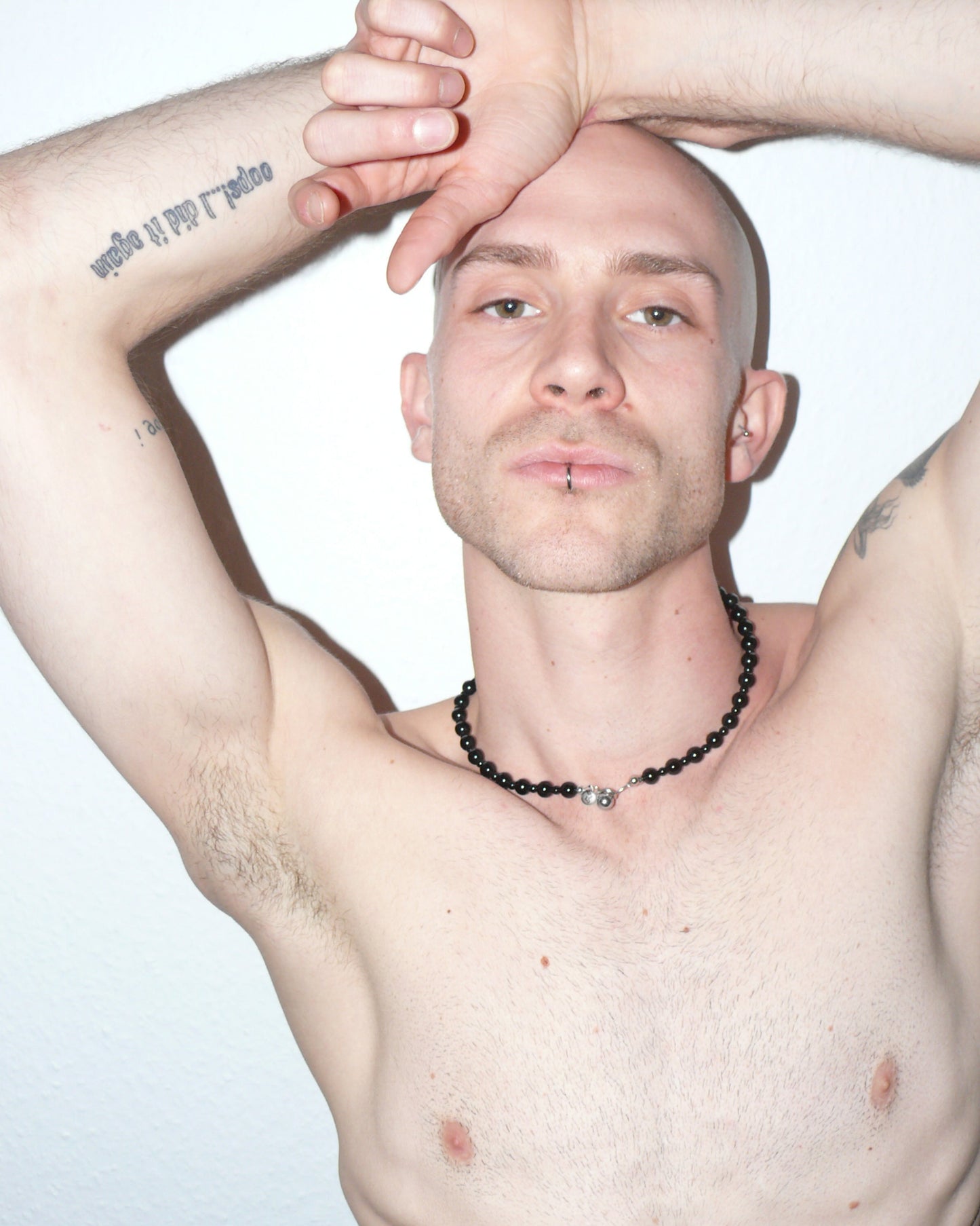 Black agate beads necklace with piercing closure close-up on model