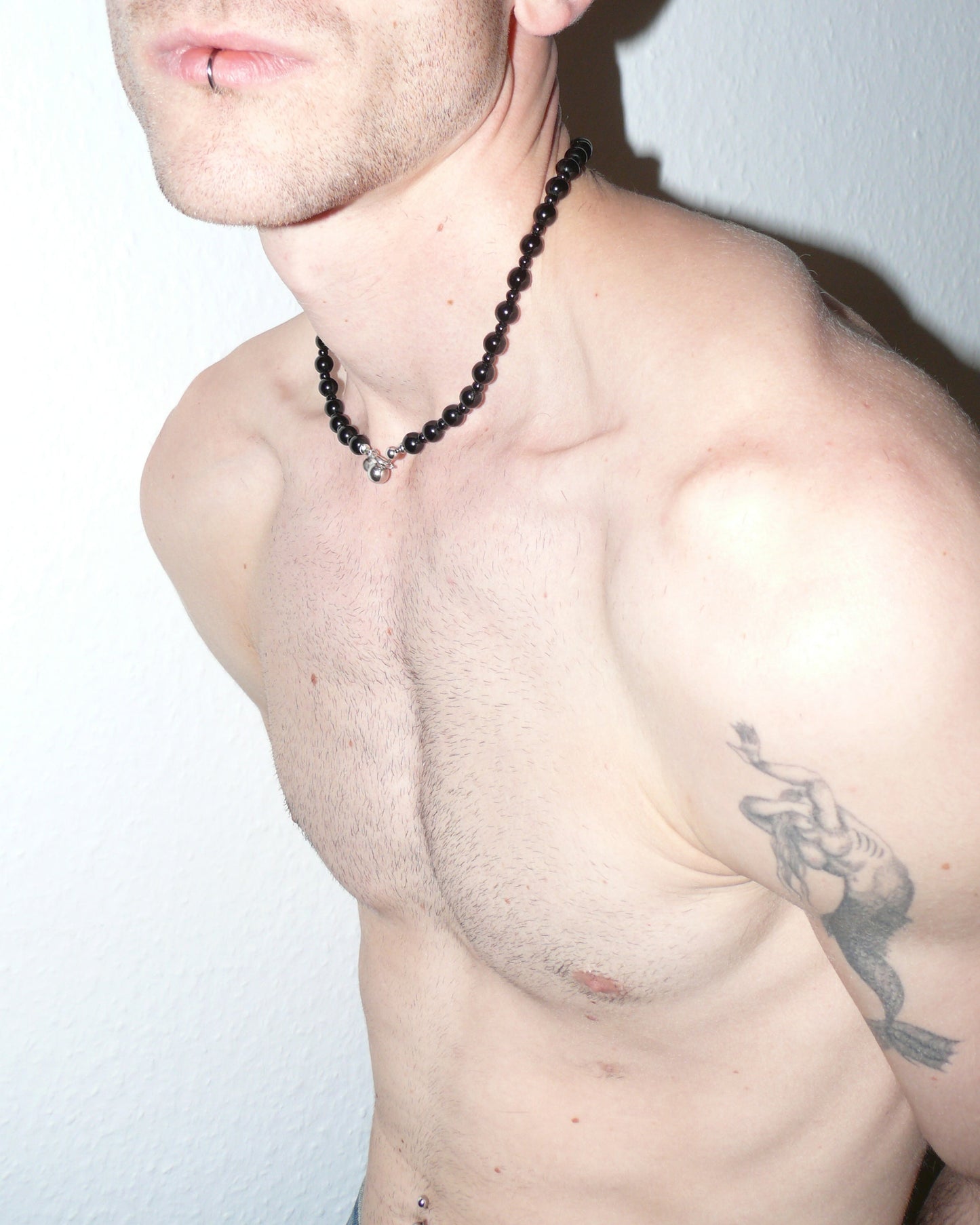 Black agate beads necklace with piercing closure side close-up on model