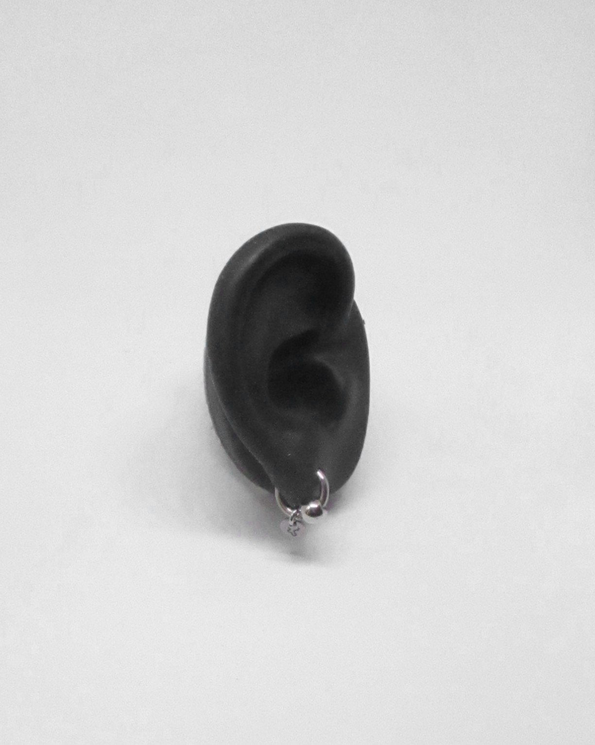 Black silicone ear on a white background