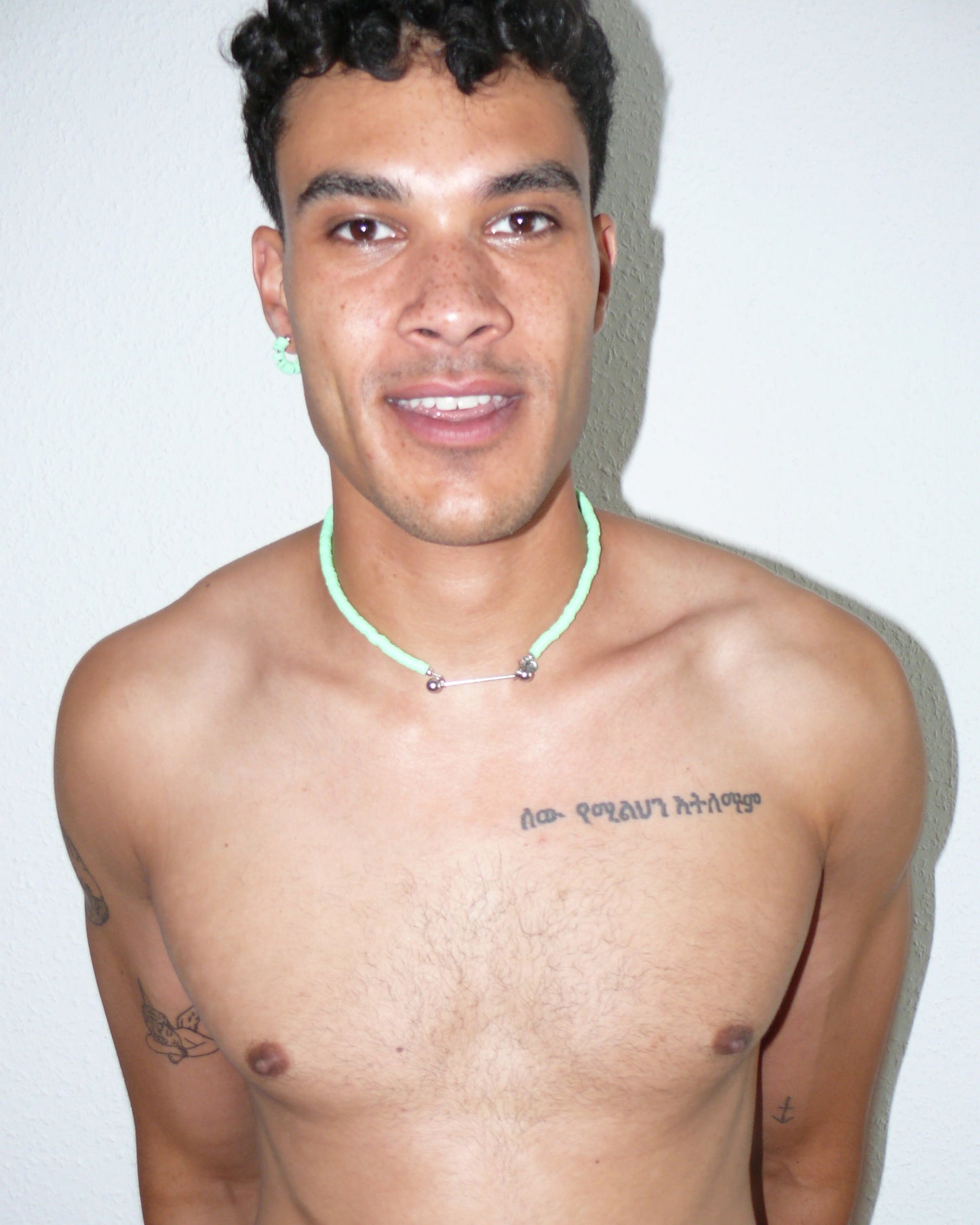 Brat green resin chips necklace with steel barbell closure portrait on smiling model