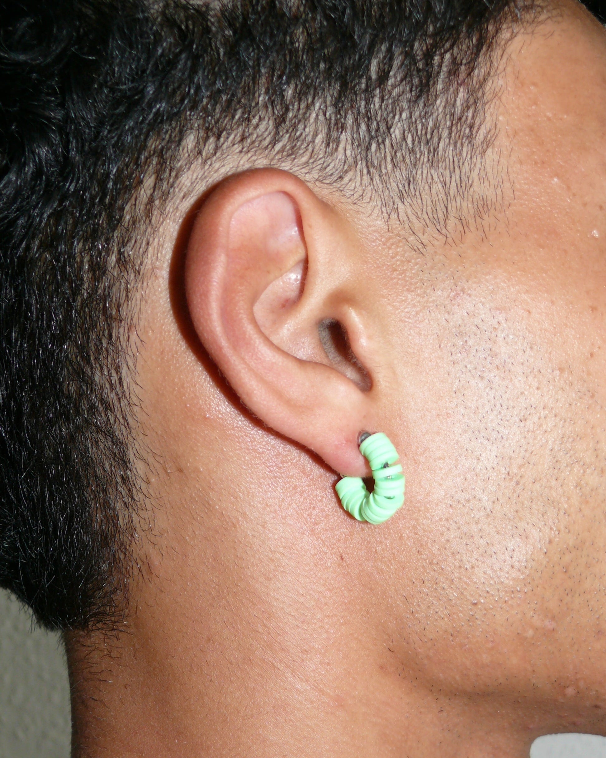 Brat green resin chips open hoops earrings close-up on model