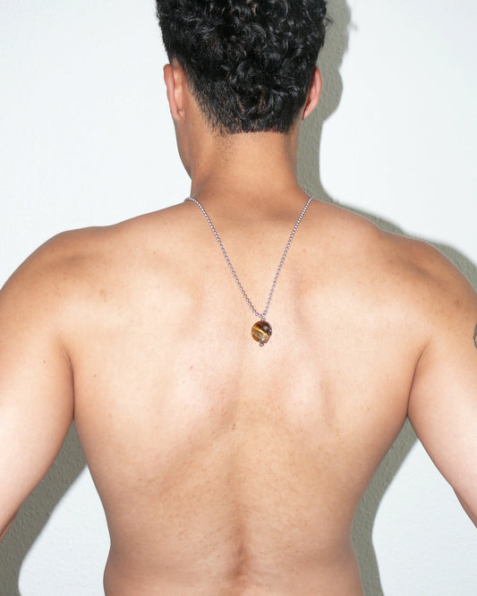 Brown tiger eye agate skull pendant necklace portrait on model back