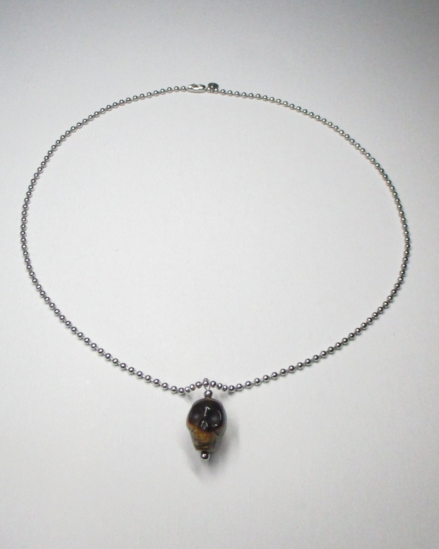 Brown tiger eye agate skull pendant necklace still portrait 