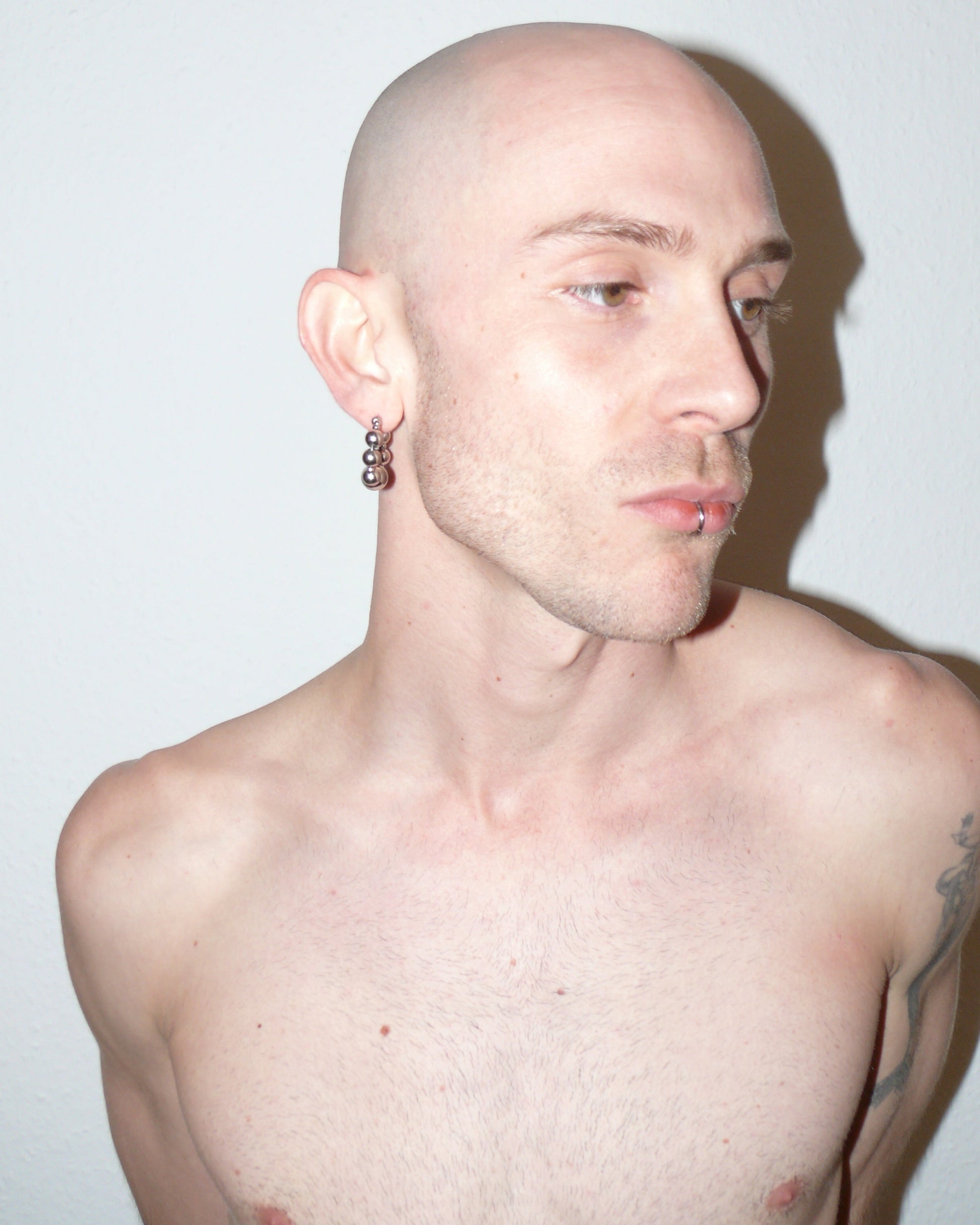 Bubbles steel hoops earrings partial side portrait on model