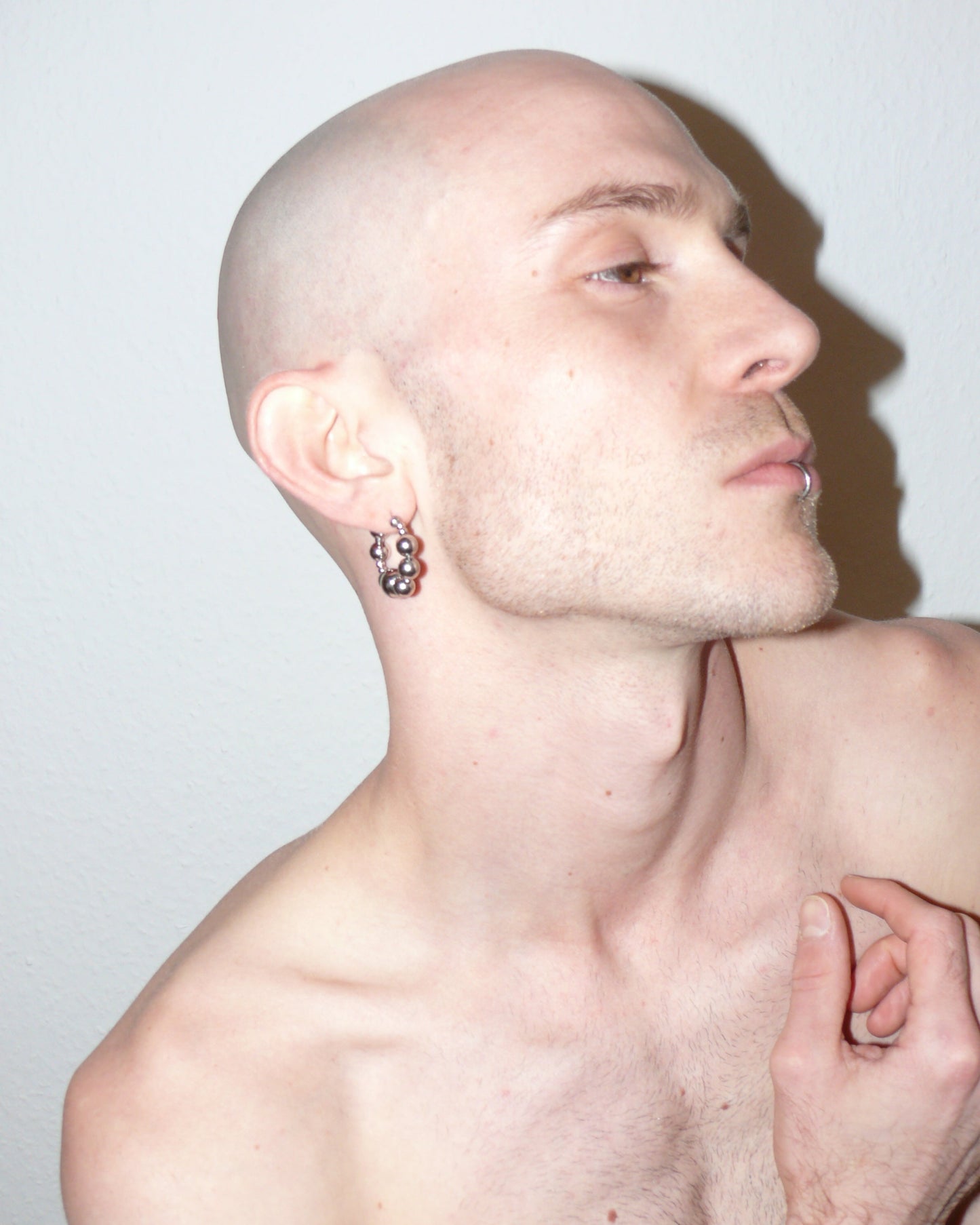 Bubbles steel hoops earrings side portrait on model