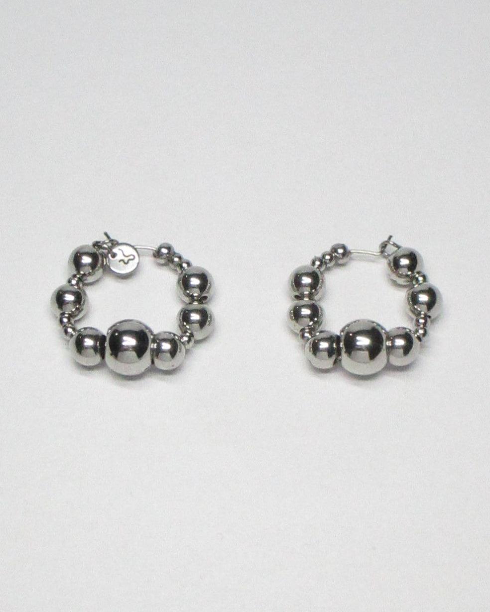 Bubbles steel hoops earrings still portrait