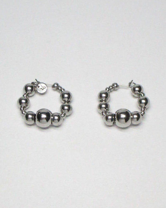 Bubbles steel hoops earrings still portrait