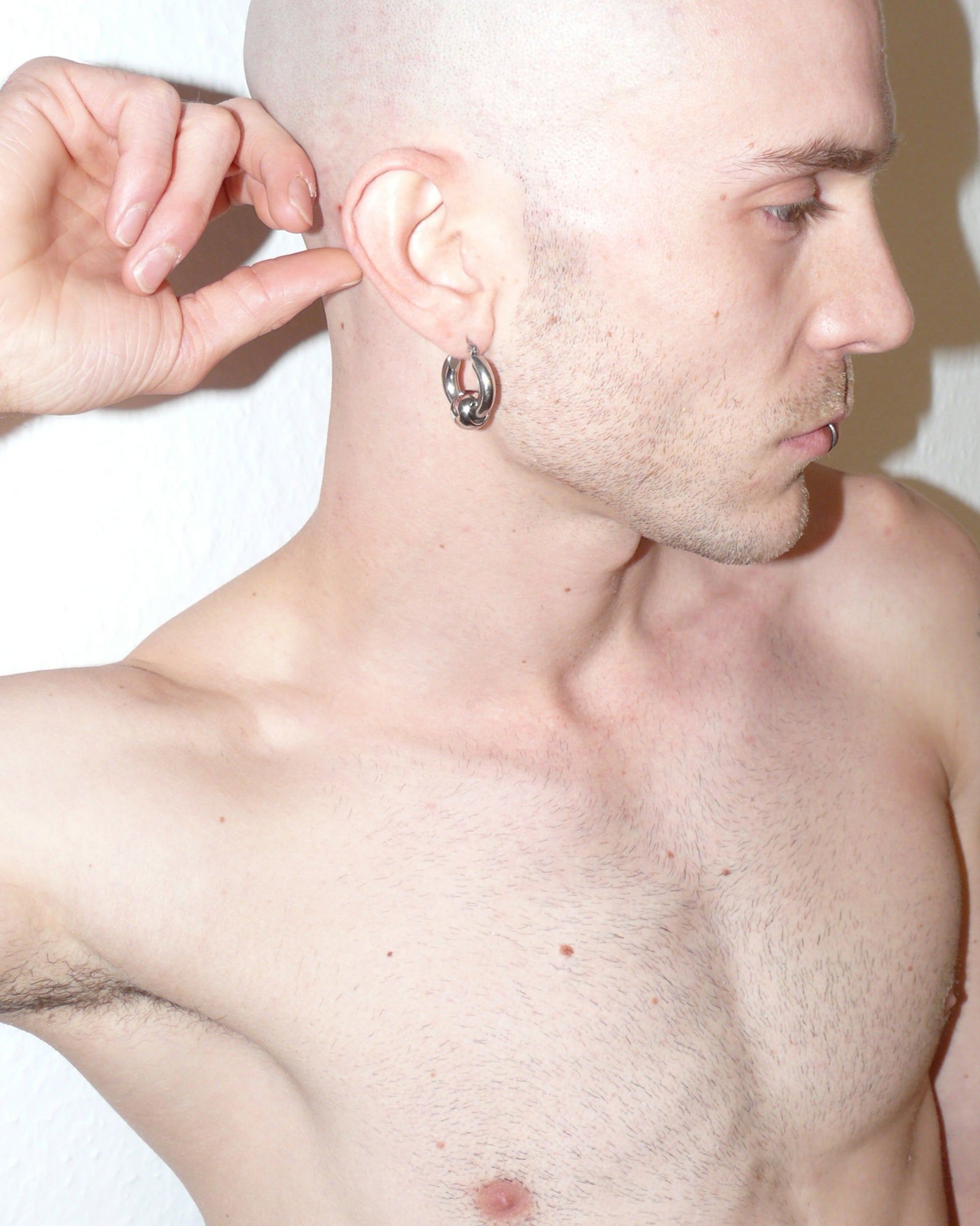 Captive style piercing steel hoops earrings side close-up on model