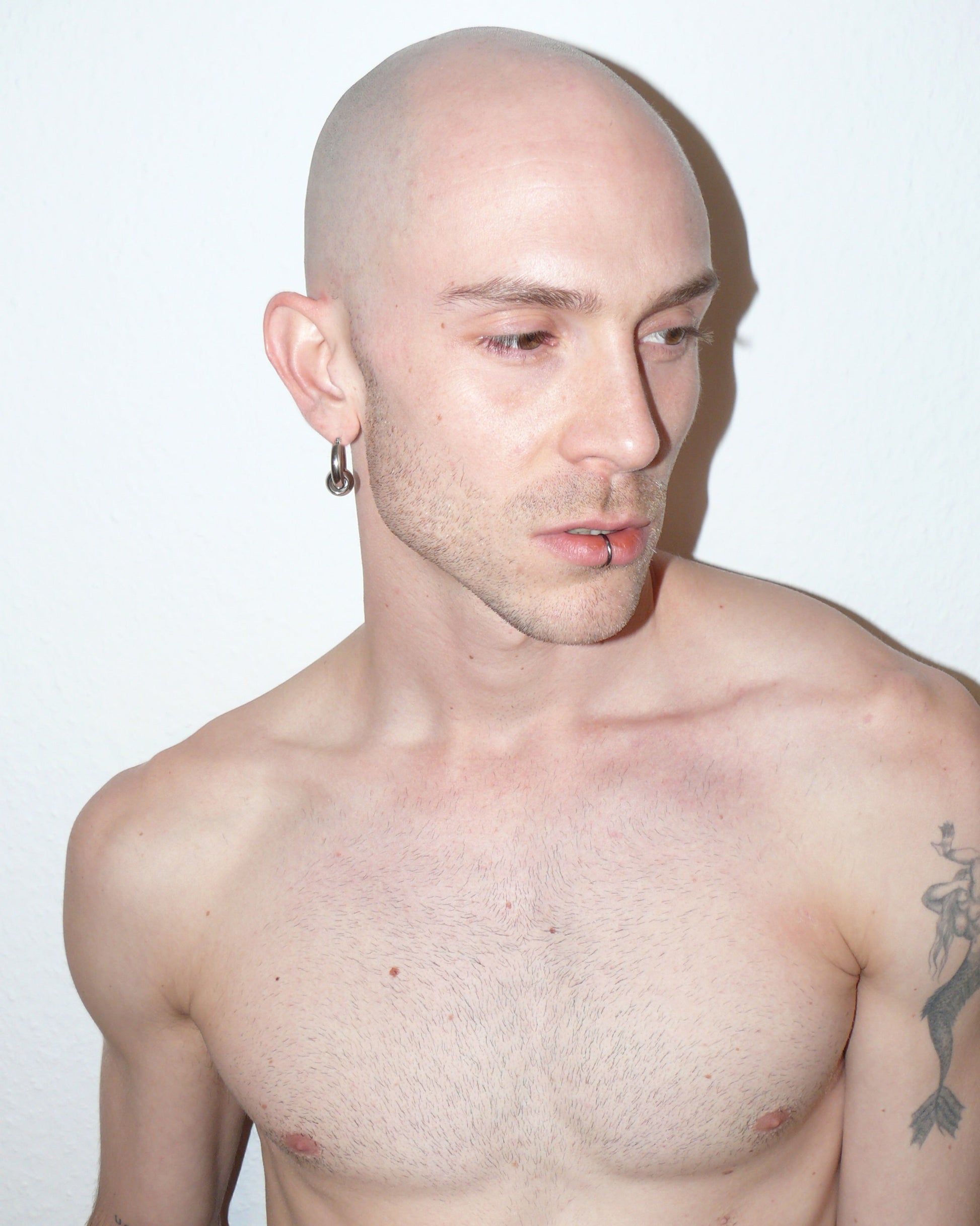 Captive style piercing steel hoops earrings side portrait on model