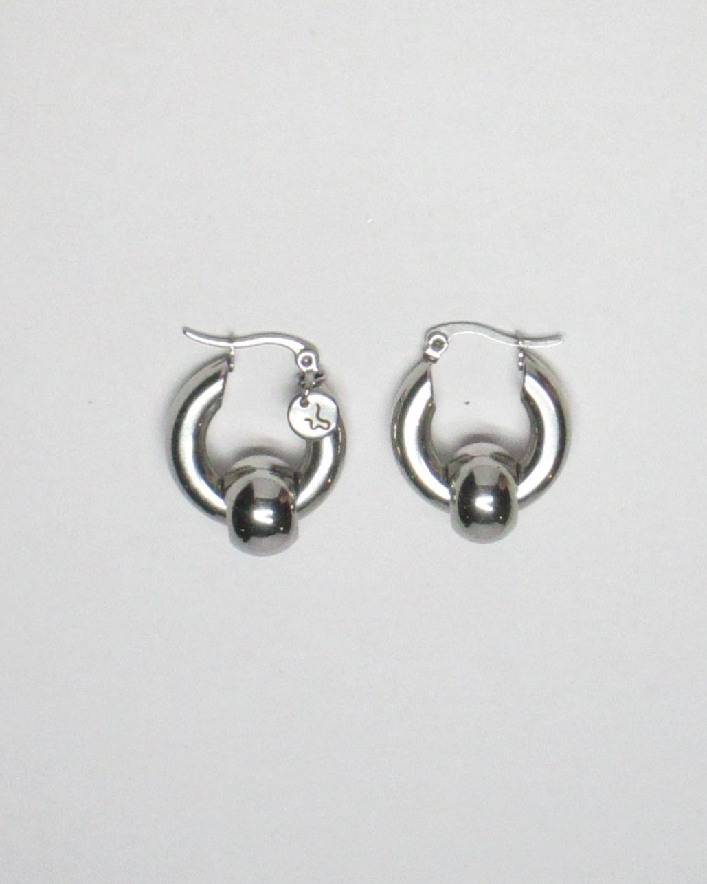 Captive style piercing steel hoops earrings top still portrait
