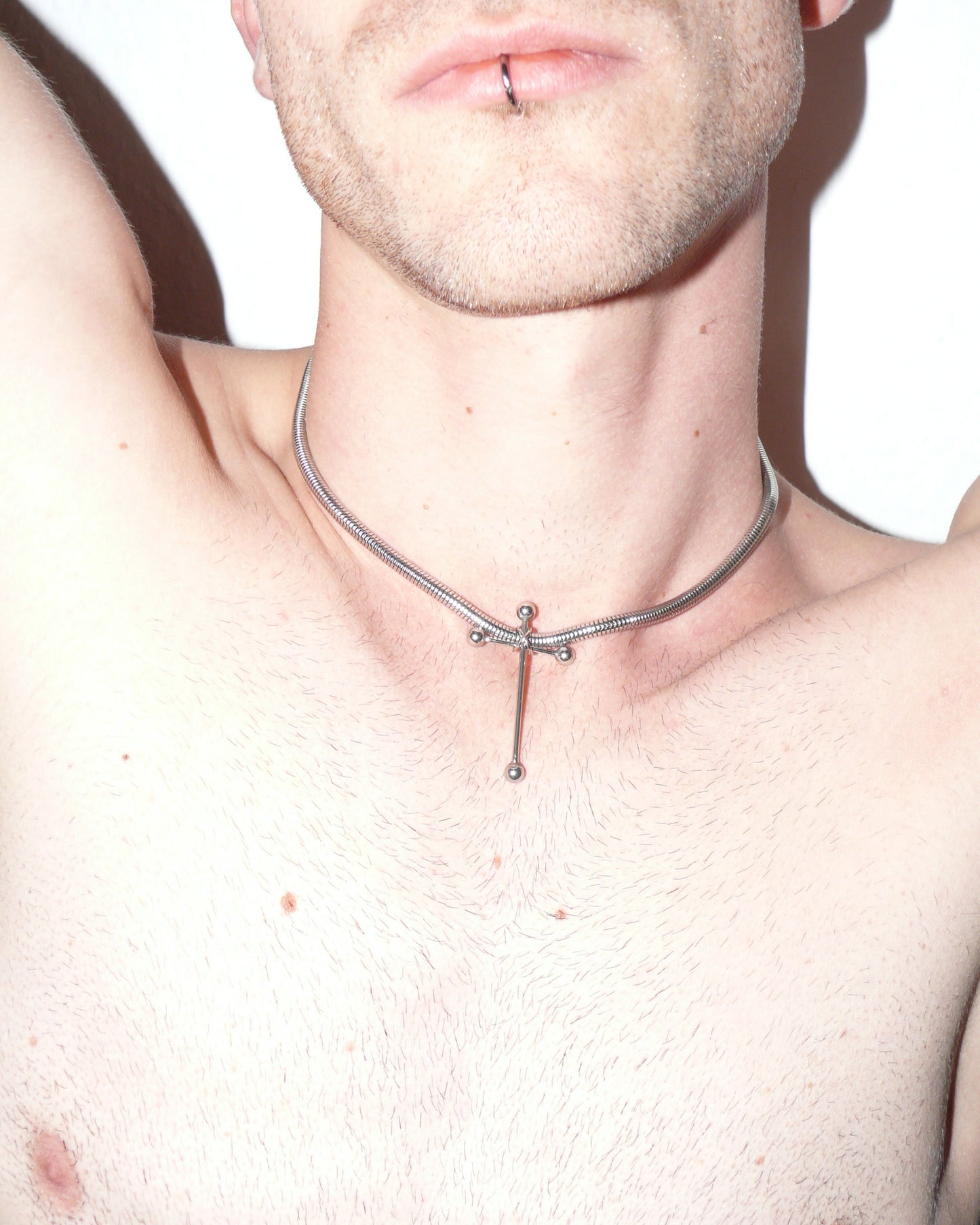 Cross shaped barbells pendant snake steel necklace close up on model