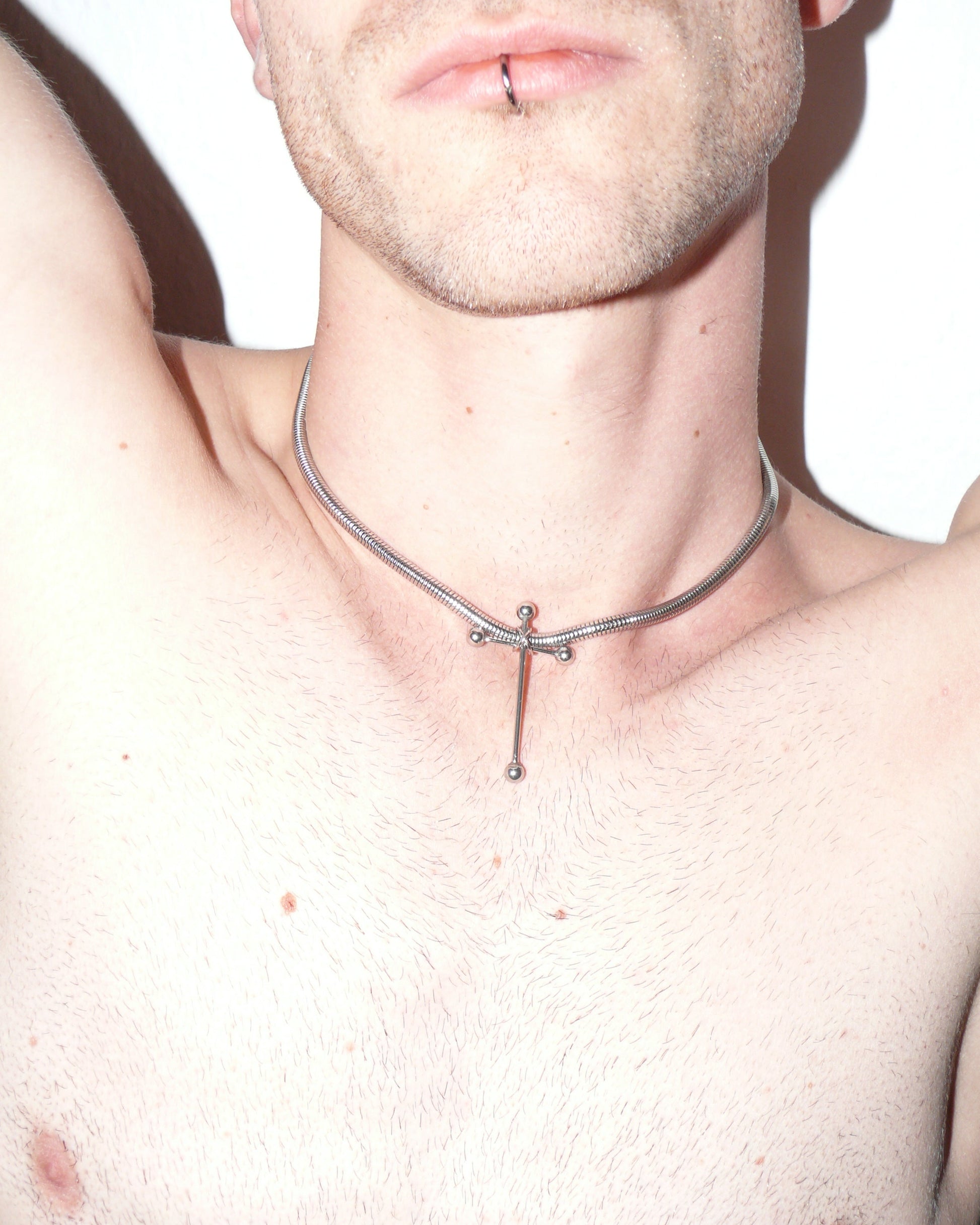 Cross shaped barbells pendant snake steel necklace close up on model