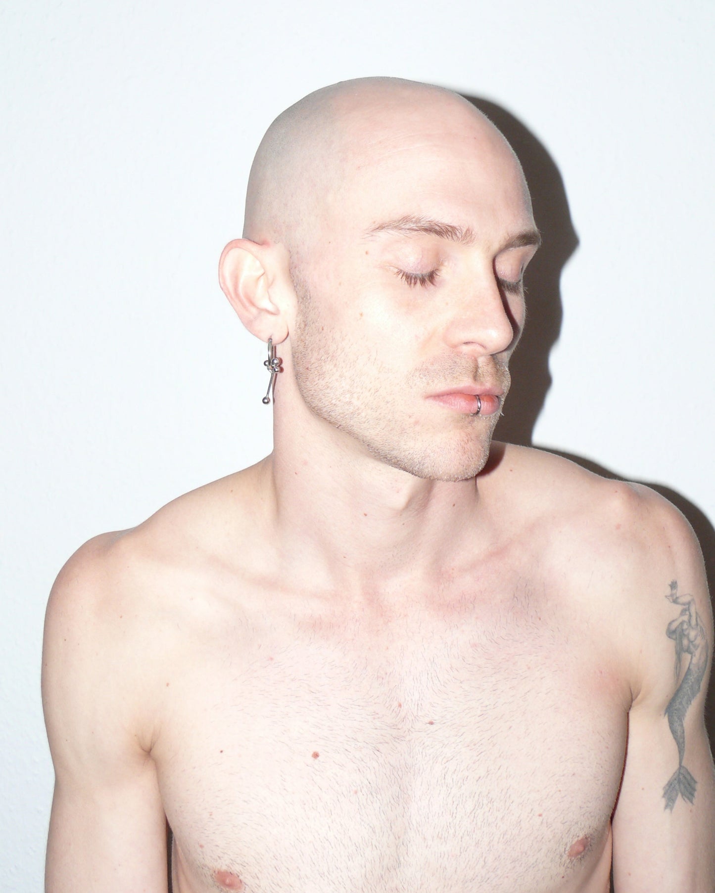 Cross shaped steel barbell hoop earrings portrait on model