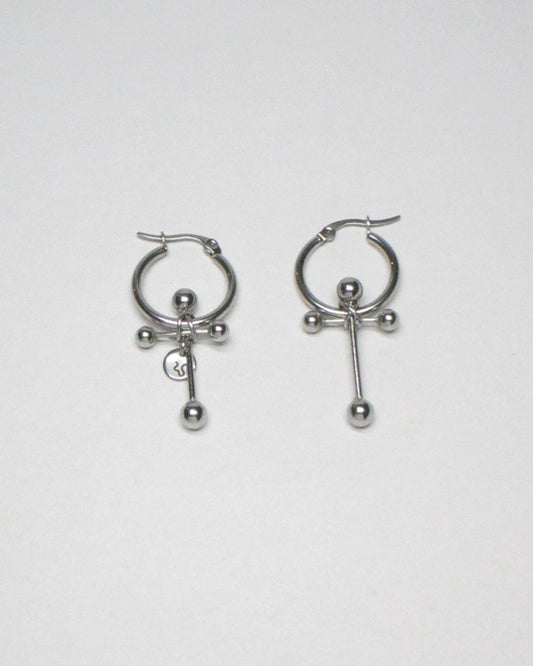 Cross shaped steel barbell hoop earrings still portrait