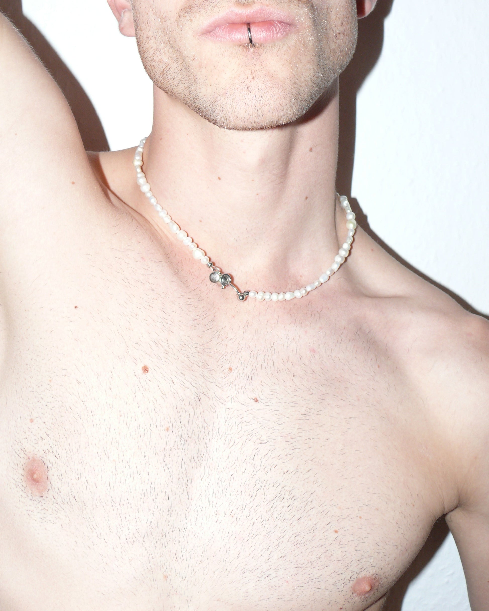 Freashwater pearls necklace with piercing closure close-up on model neck