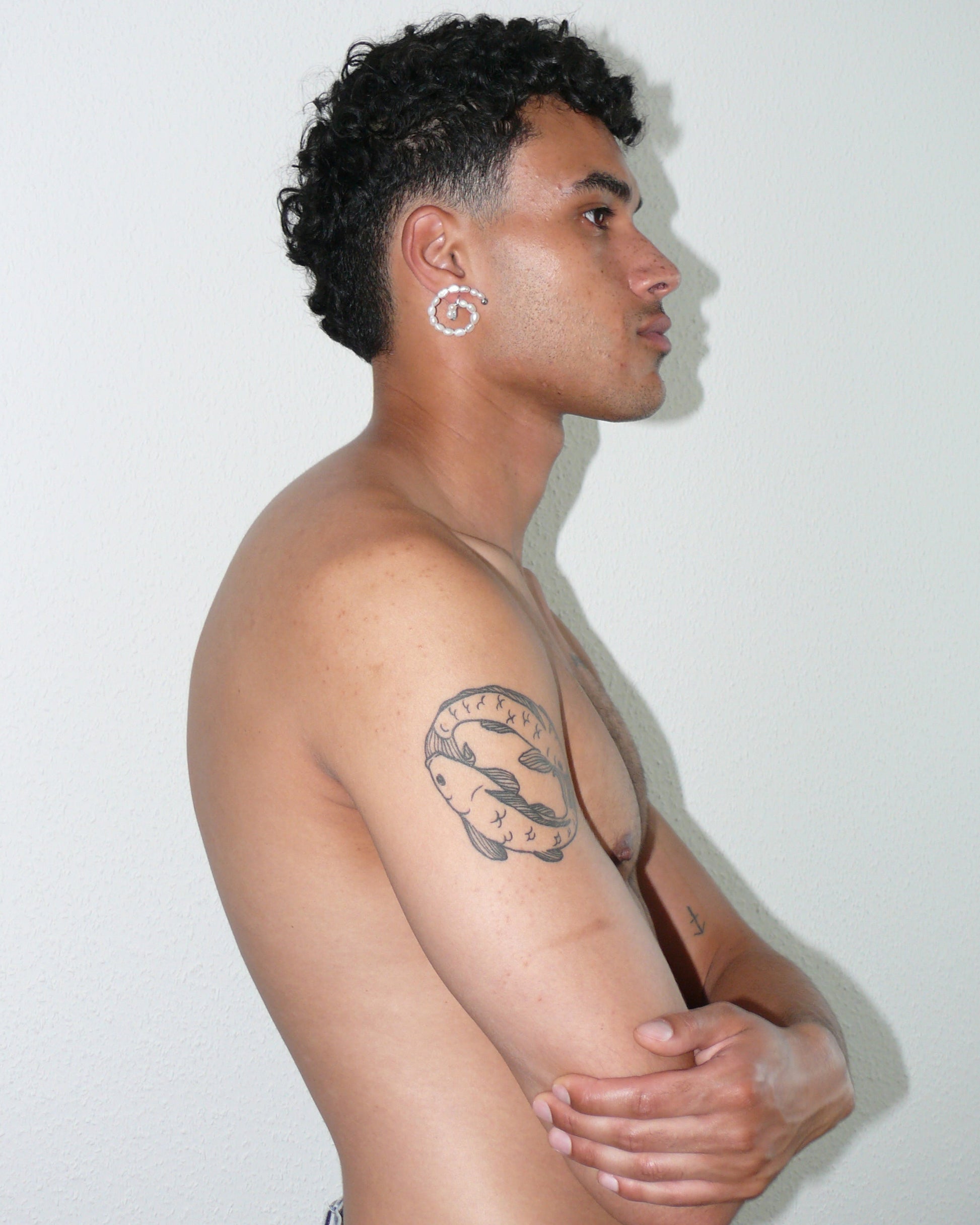 Freshwater pearls spiral button earrings side portrait on poc model