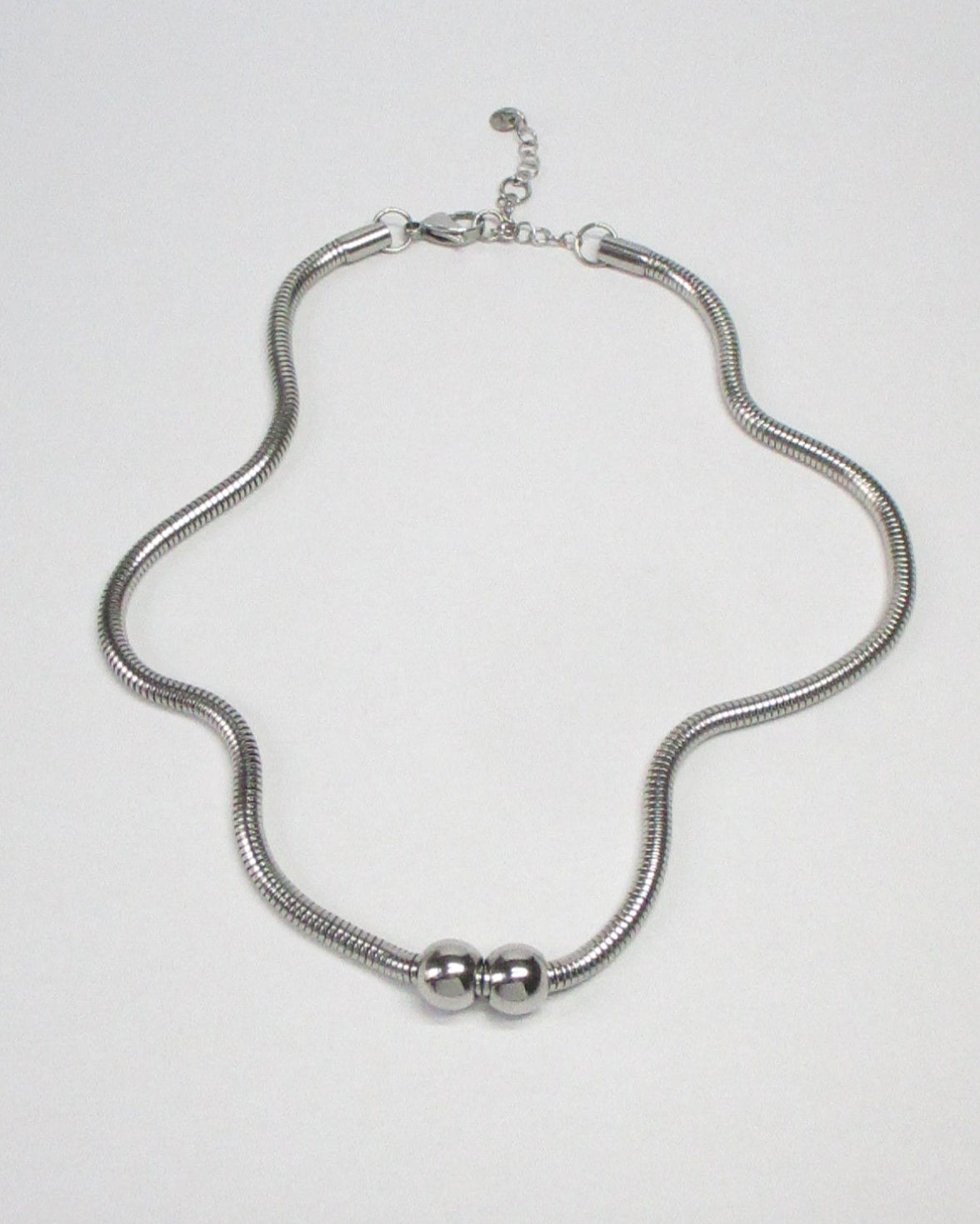 Gemini boulles steel necklace fluid still portrait