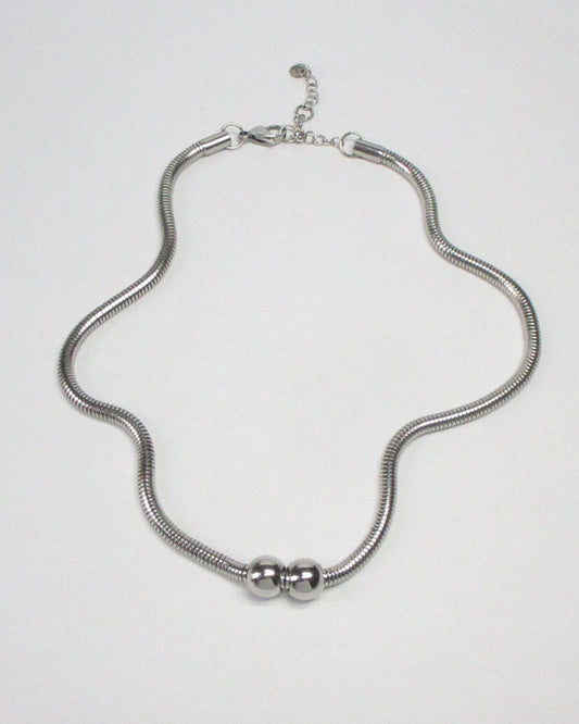 Gemini boulles steel necklace fluid still portrait