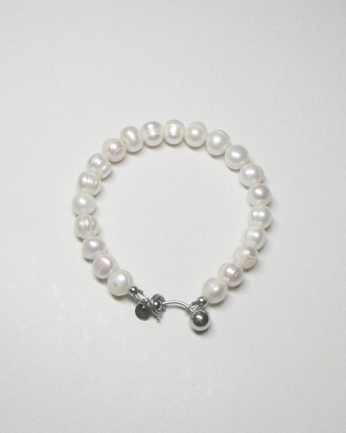 Gemstone freshwater pearls bracelet with piercing closure still portrait