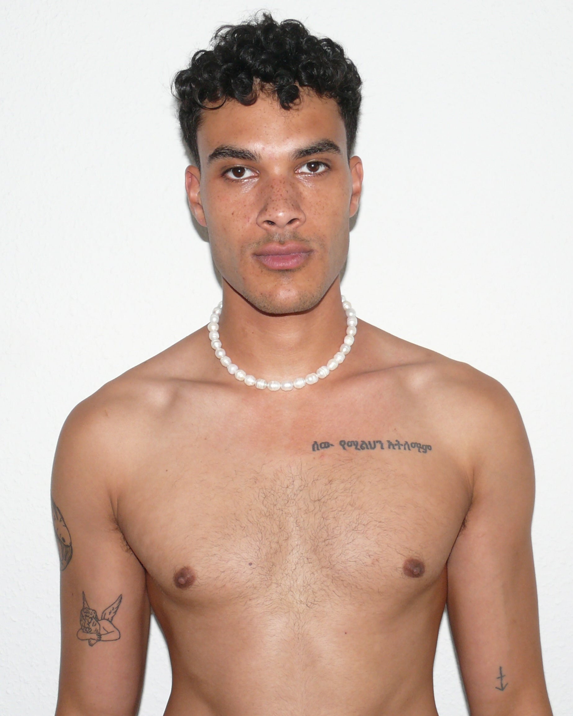 Gemstone freshwater pearls necklace with piercing closure portrait on poc model with arms down