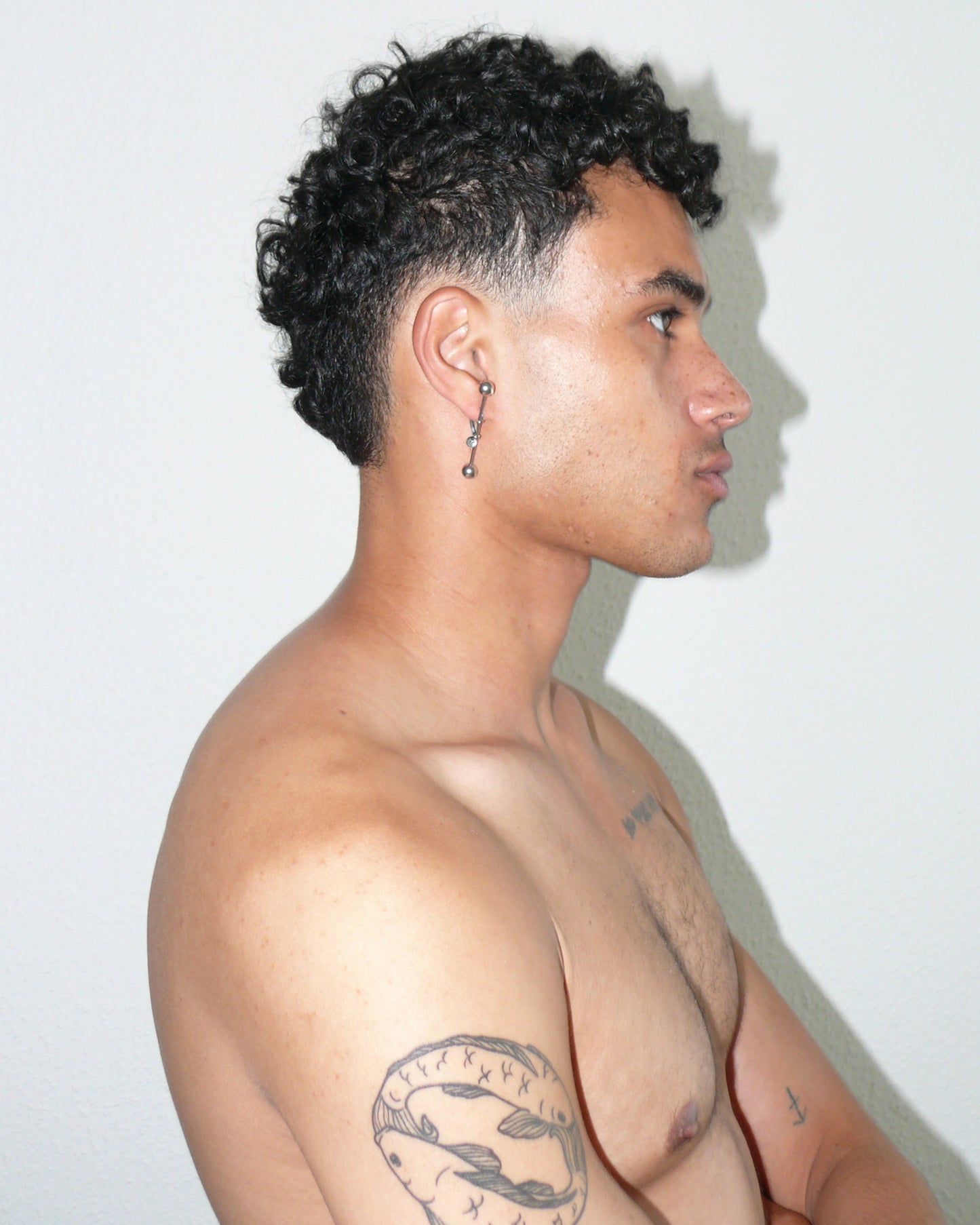 Maxi barbell piercing single earring side portrait on poc model