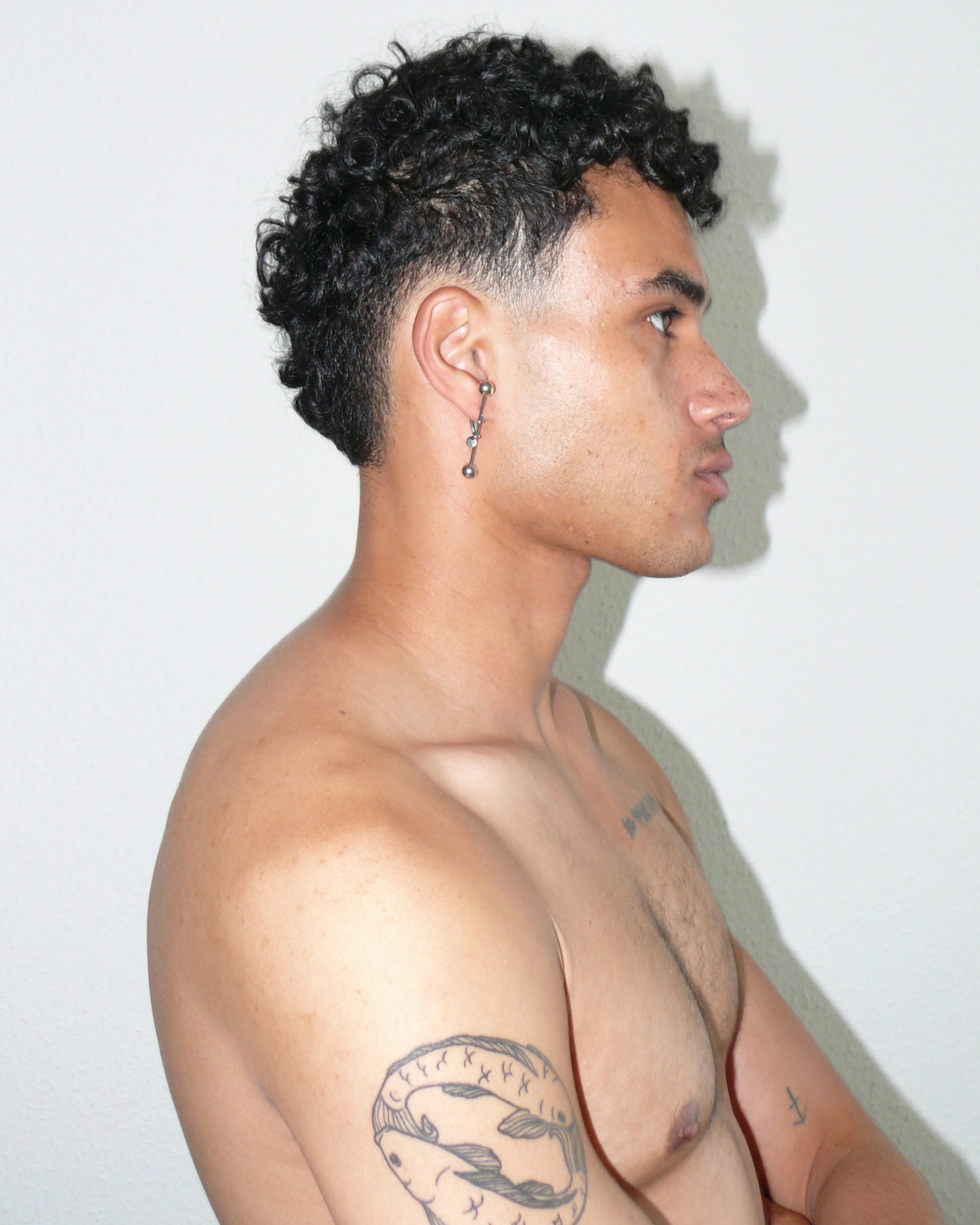 Maxi barbell piercing single earring side portrait on poc model