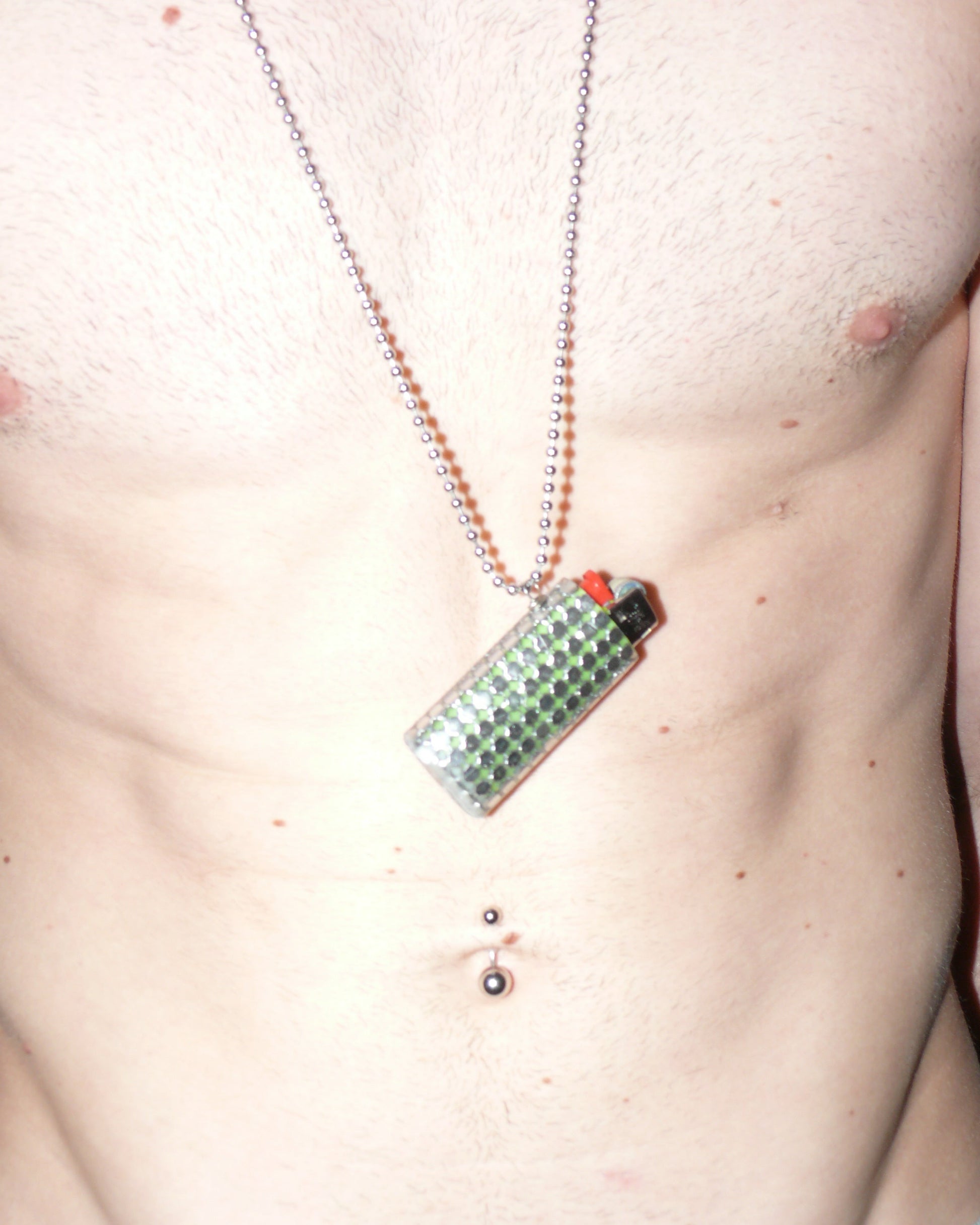 Metal mesh lighter case casted in transparent resin with chain close up on model torso