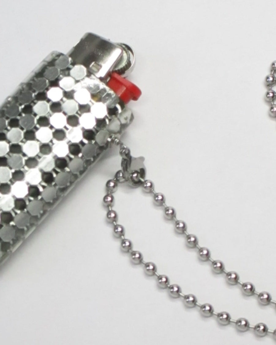 Metal mesh lighter case casted in transparent resin with chain still close up lateral portrait