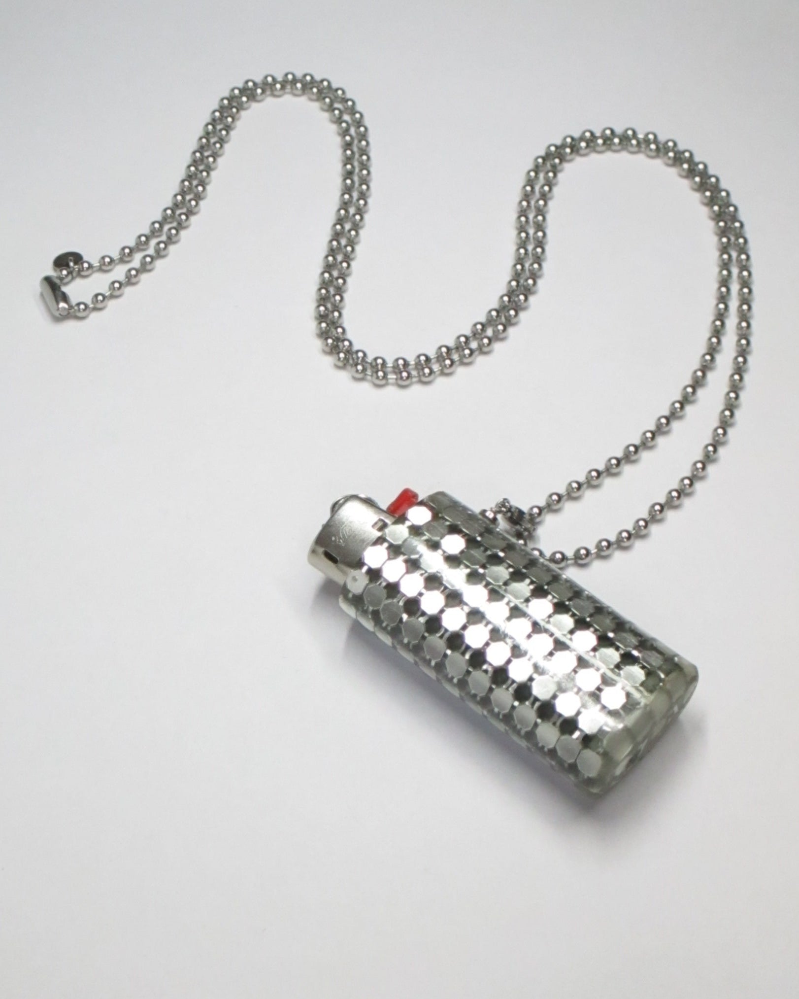 Metal mesh lighter case casted in transparent resin with chain still portrait