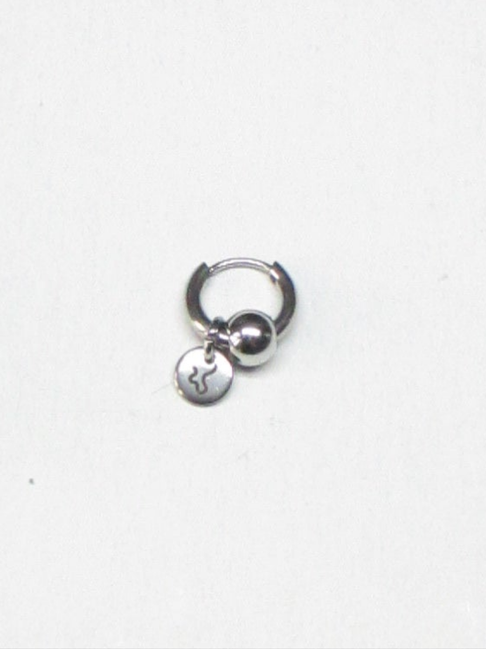 Micro captive piercing style steel single earring still portrait