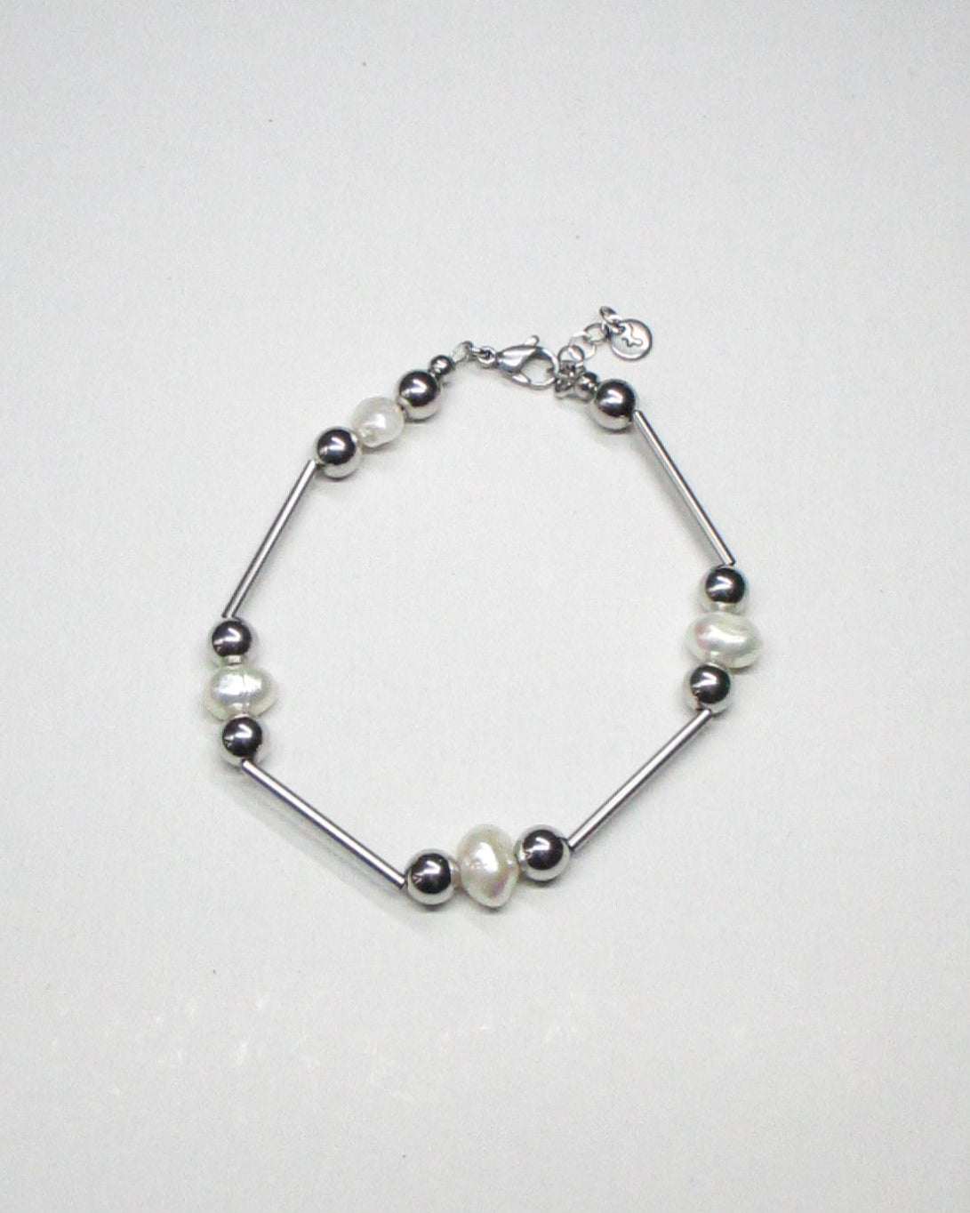 Mille barbells steel and freshwater pearls bracelet still portrait