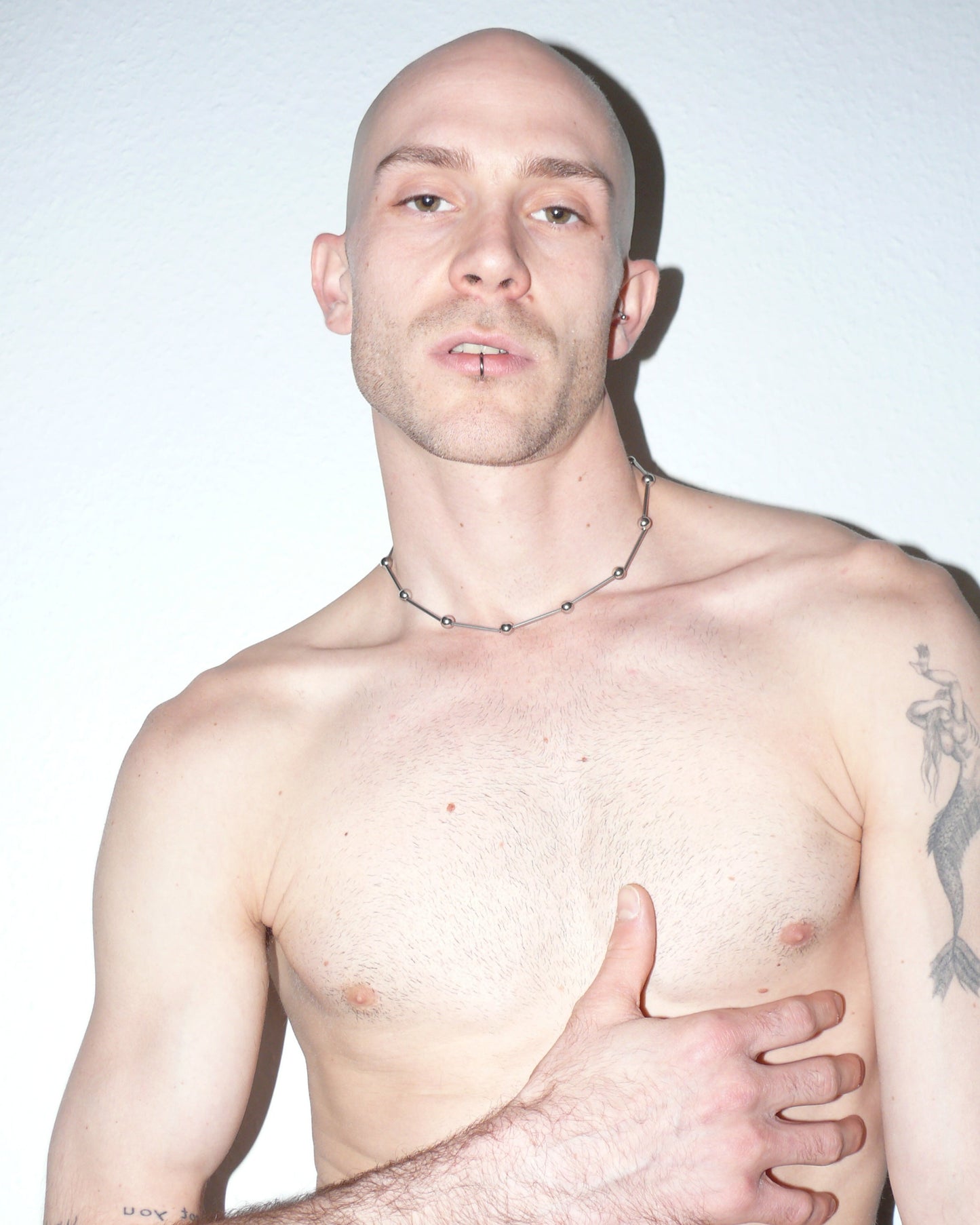 Mille barbells steel necklace portrait on model touching torso