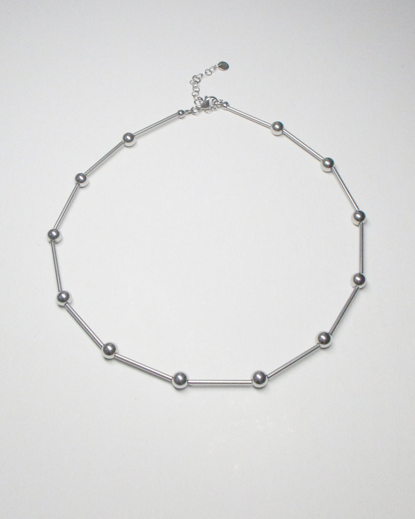 Mille barbells steel necklace still portrait