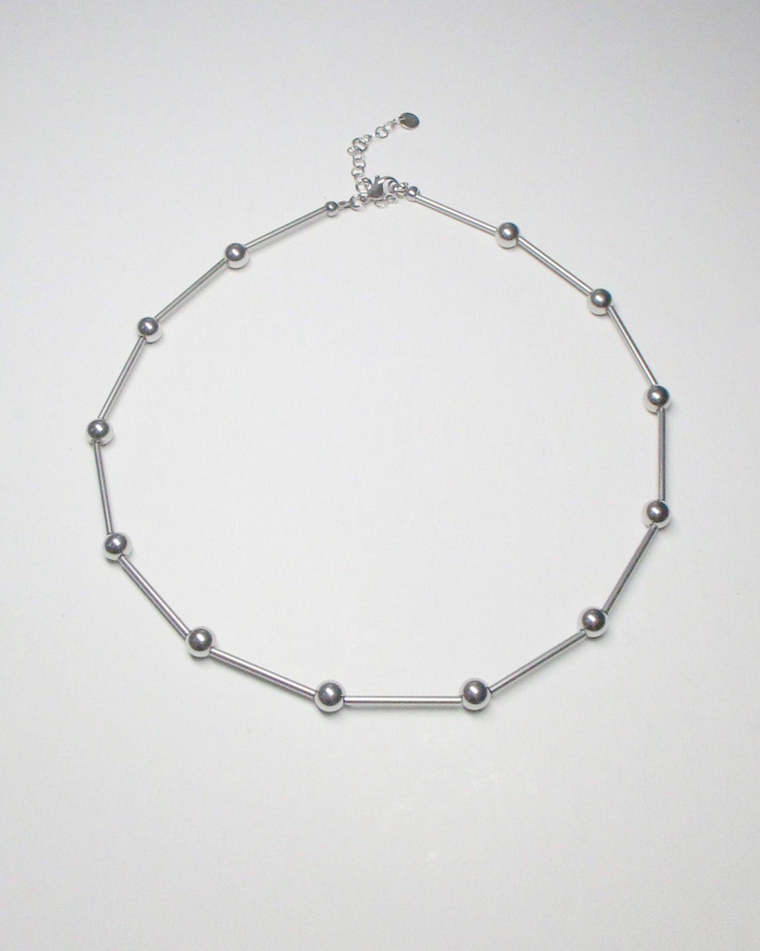 Mille barbells steel necklace still portrait