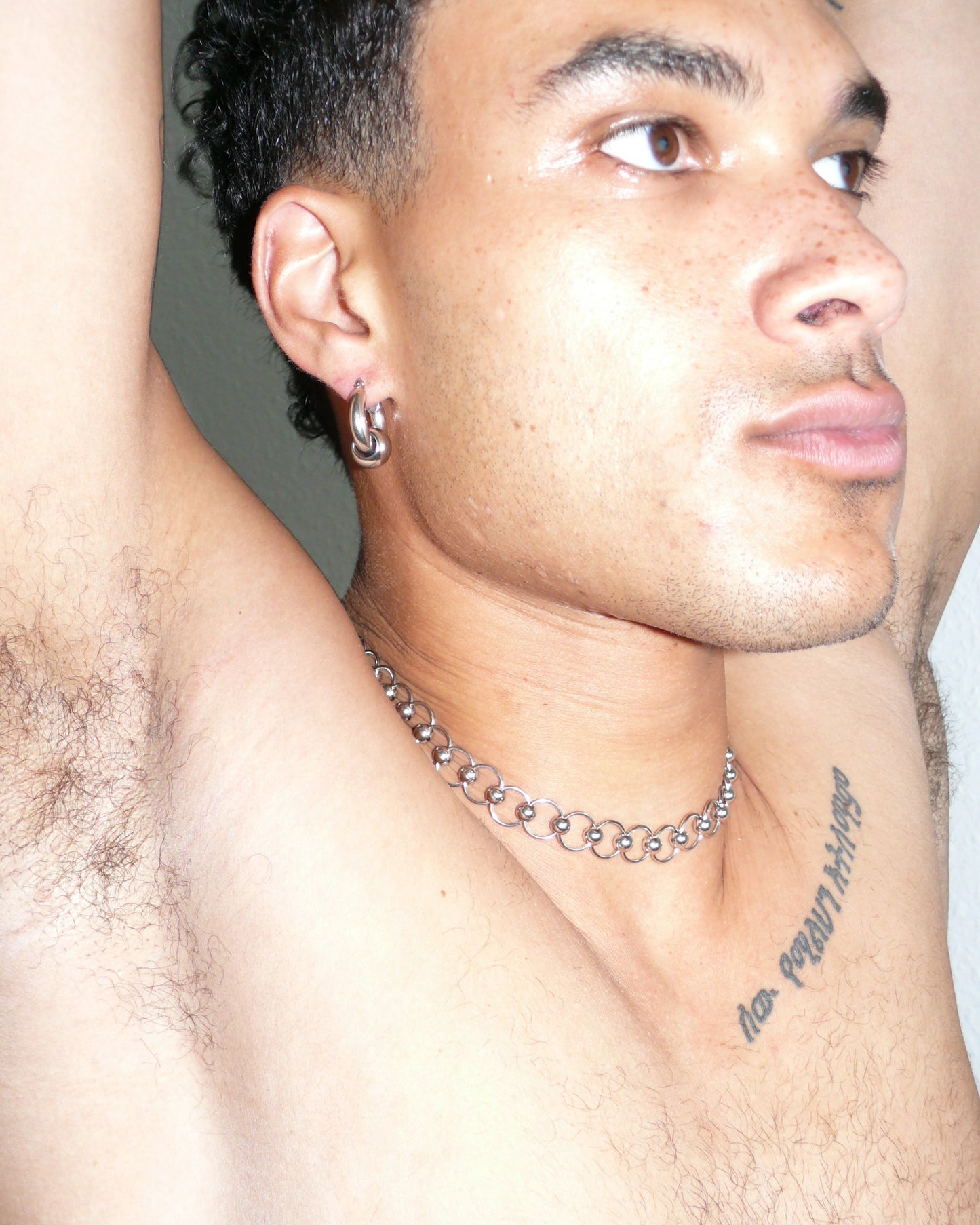 Mille captive style piercing steel necklace close-up on poc model