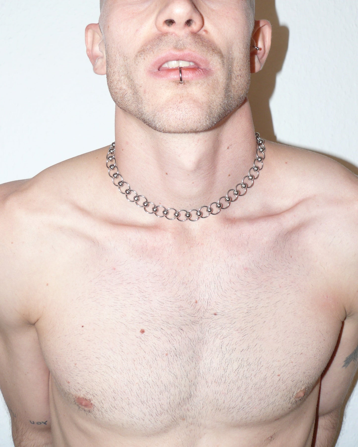 Mille captive style piercing steel necklace frontal close-up on model with open mouth