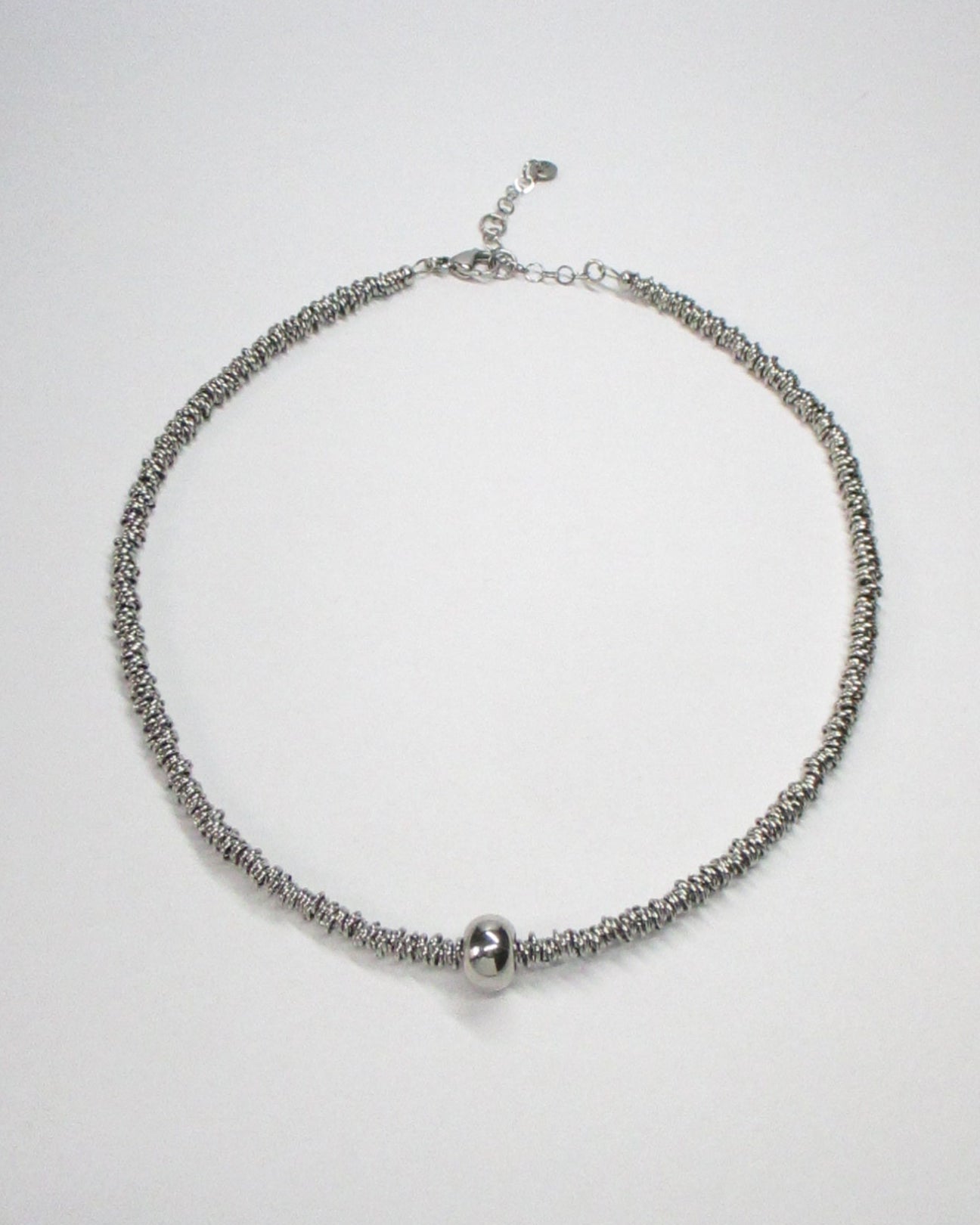 Mille steel rings necklace with central boulle decoration still portrait